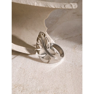 Polished silver leaf open ring in stainless steel on minimalist stone background