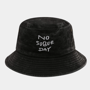 Close-up of the NO SOBER DAY embroidery and metal eyelets on this washed cotton bucket hat