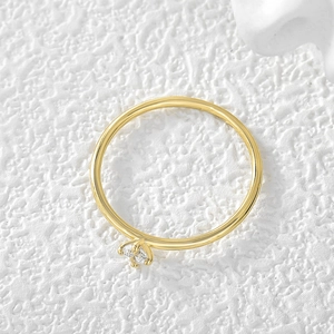 Elegant four-prong solitaire round zircon ring in gold plating on white textured background