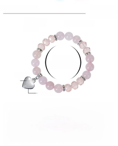 Détail du bracelet en perles de cristal rose avec breloque cœur personnalisée en acier