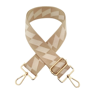Detail of adjustable 5cm beige geometric diamond pattern strap with gold metal hooks