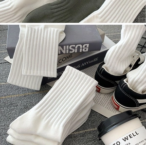 Close-up of white ribbed knit cotton socks showing premium texture and breathable fabric