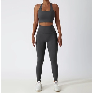 Front full view of women's dark gray two-piece yoga set with sports bra and high-waist leggings