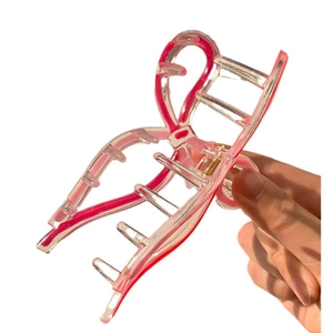 Pink jelly ribbon bow hair claw clip made of transparent acrylic with gold metal spring