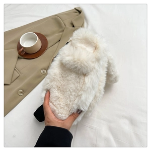 Close-up of white plush bunny tote bag with cute rabbit ears in a lifestyle setting