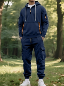 Detailed view of navy blue men's fleece hoodie and cargo pants set in outdoor nature