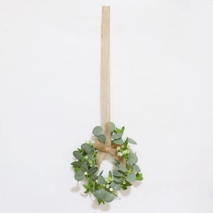 Artificial eucalyptus wreath with white flowers and burlap bow for spring wall decor