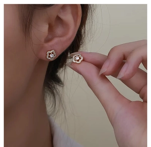 Close-up of plum blossom S925 silver stud earring with micro-set white zircons