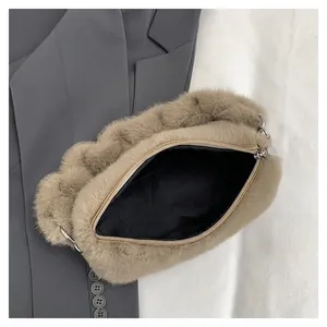 Chic khaki faux fur handbag with zipper closure shown on a minimalist grey suit background