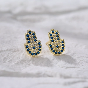 Gold Hamsa Hand stud earrings with blue and white pavé cubic zirconia gemstones