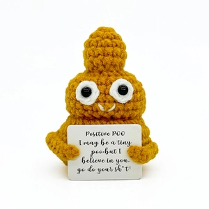 Handmade crochet positive poo doll holding inspirational card on a white background