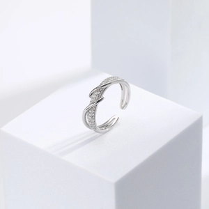 Macro shot of silver S925 ring featuring intertwined bands and sparkling micro-inlaid zircons