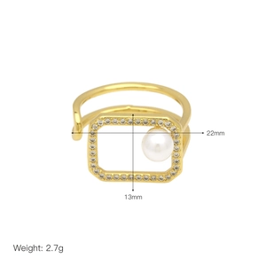 Detail view of 18k gold ring with square cubic zirconia frame and pearl accent