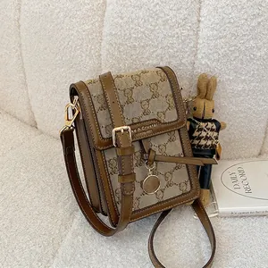 Vintage brown canvas embroidery shoulder bag with teddy bear pattern and bunny doll charm
