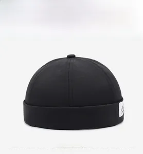 Front view of black breathable Docker hat with retro streetwear style and white side label