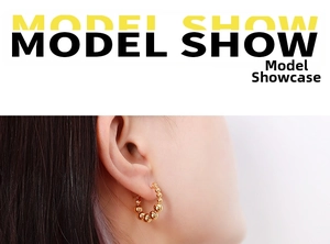 Detail of model wearing French style gold-plated titanium bead hoop earrings for women