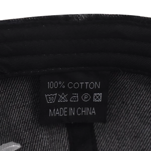Detailed macro shot of the washed denim cap 100% cotton label and fabric texture