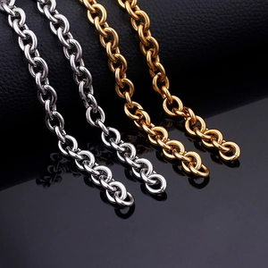 Polished stainless steel O-link chains in gold and silver finish on a black leather base