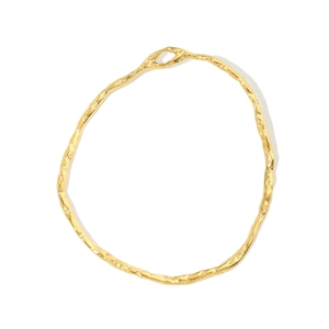 Close-up of golden irregular ring pendant with hammered texture on white background