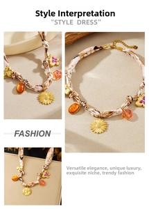 Detail of sunflower and amber resin charms on a leopard print ribbon necklace