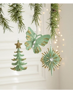 Detail of mint green butterfly and star Christmas tree ornaments with glitter finish