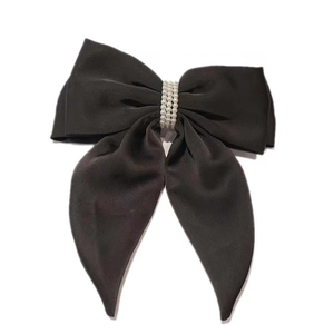 Elegant black satin bow hair clip with three rows of white pearls on white background