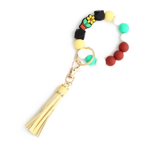 Portachiavi da polso con perline di silicone, girasole e nappa in pelle gialla
