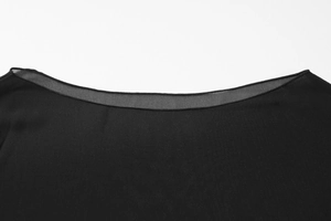 Detail of the black chiffon blouse neckline featuring delicate sheer mesh trim and texture