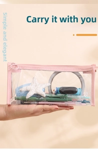 Macro detail of a transparent PVC pencil case with pink trim and smooth zipper closure