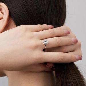Detail of an S925 sterling silver ring with a large oval cubic zirconia on a model's hand