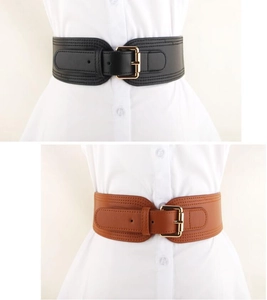 Detail of wide elastic waist belt with PU leather front and gold metal buckle accents