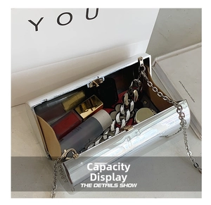 Detailed interior of a silver acrylic cylinder clutch bag showing storage capacity