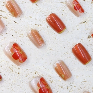 Short square red cat-eye press-on nails with floral hand-painted art and gold edges