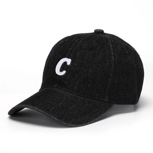 Close-up of vintage black washed denim baseball cap with white embroidered letter C