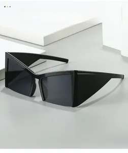 Close-up of black oversized geometric sunglasses with sharp angular feline design