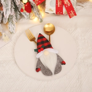 Gnome Christmas cutlery holder with red plaid hat on white plate for table decoration