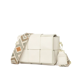 Close-up of cream woven leather square bag with patterned geometric wide shoulder strap