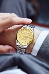 Detail of men's steel watch with gold-silver strap and diamond hour markers on gold dial