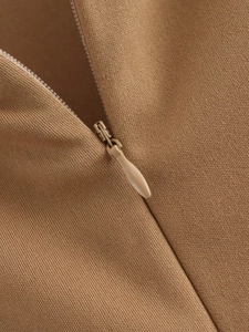 Close-up of invisible zipper and khaki knitted fabric texture on the dress