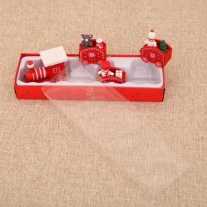 Detail view of red wooden Christmas train set with teddy bear and snowman on burlap base