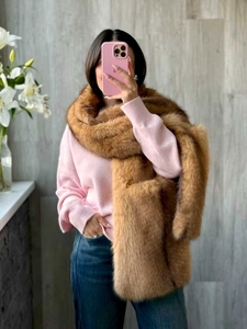 Macro detail of dense brown faux fox fur stole with fluffy texture on model