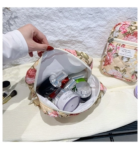 Detailed interior view of floral quilted toiletry bag showing spacious capacity and soft fabric