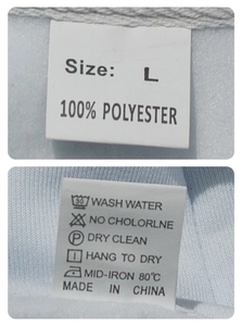 Detail of clothing care label showing size L and 100% polyester fabric composition