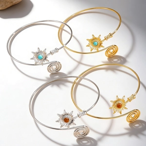 Close-up of bohemian sun arm cuffs with turquoise stones in gold and silver finishes