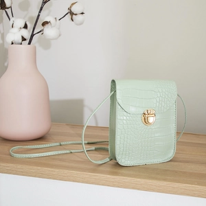 Pale green crocodile pattern mini crossbody bag with a gold twist-lock and slim strap