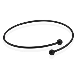Macro detail of minimalist black stainless steel open cuff bracelet with spherical ends
