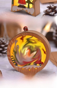 Detail of wooden LED Christmas ornament with star and circle frame on snow background
