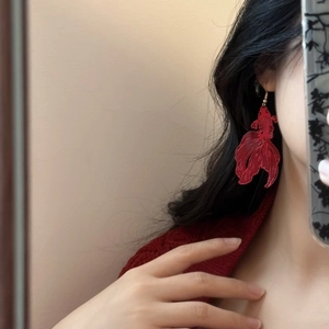 Mirror selfie showing large red koi fish drop earrings with hollow metal craft on ear