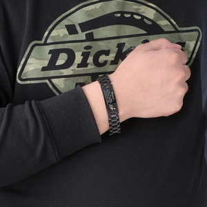 Detail of black stainless steel bracelet with inspirational engraving and Horus eye symbol