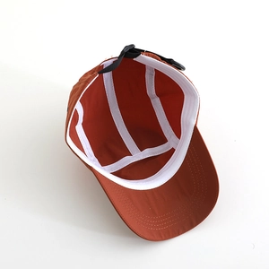 Inside view of rust orange camper cap with adjustable strap and breathable lining